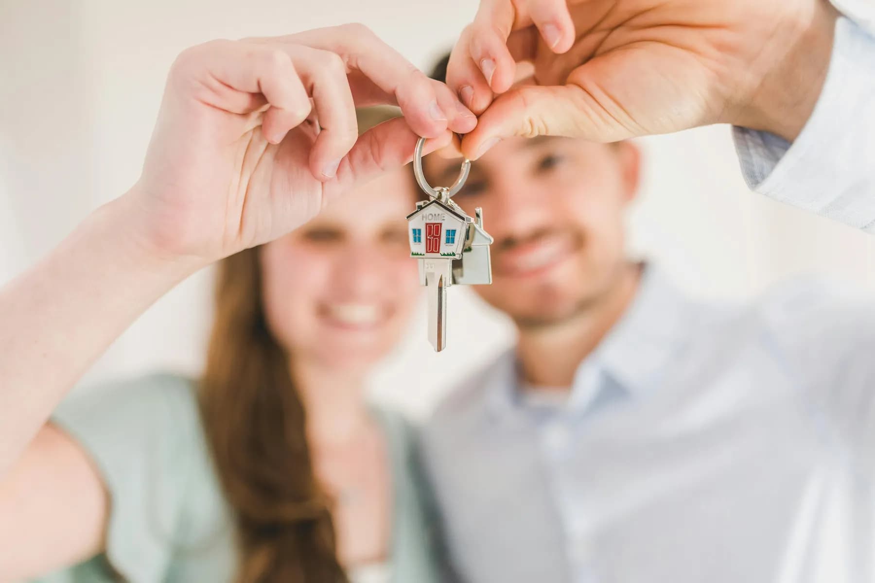 A couple holding the keys to their first home